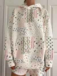 Floral patterned hoodie and shorts set against a neutral background